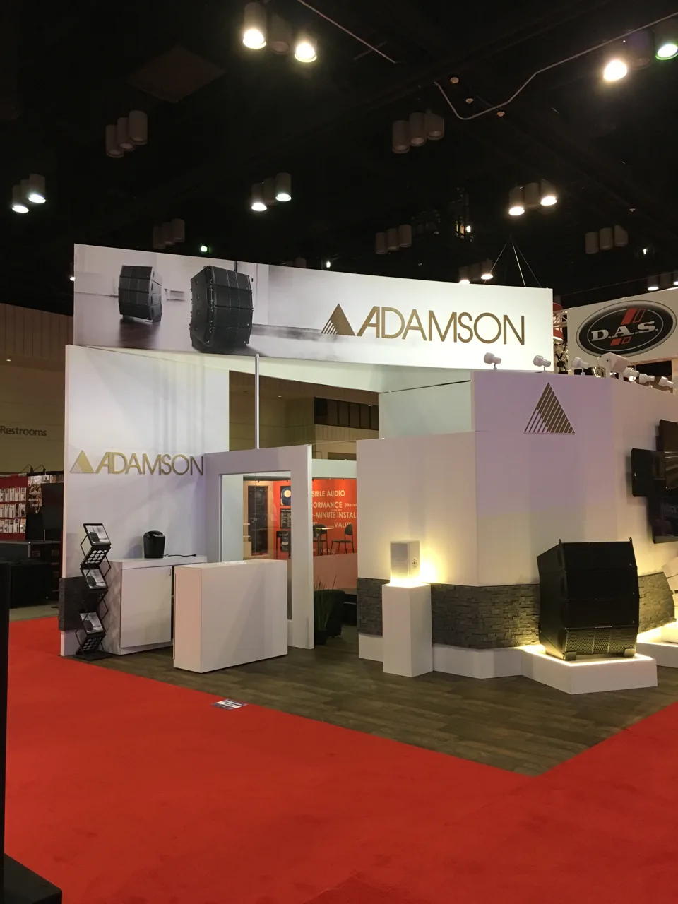 Adamson exhibit with white angular walls on red carpet