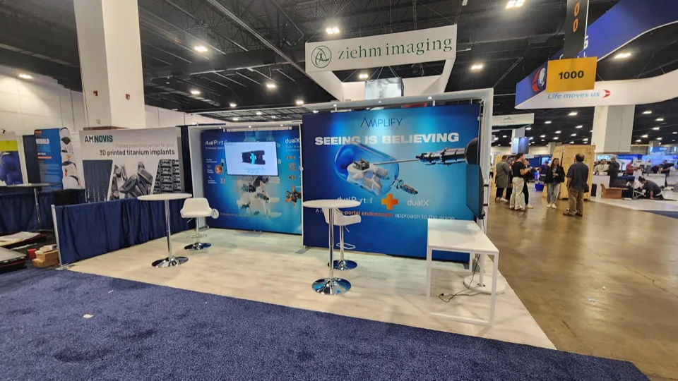 Amplify Surgical inline exhibit with Seeing Is Believing graphic