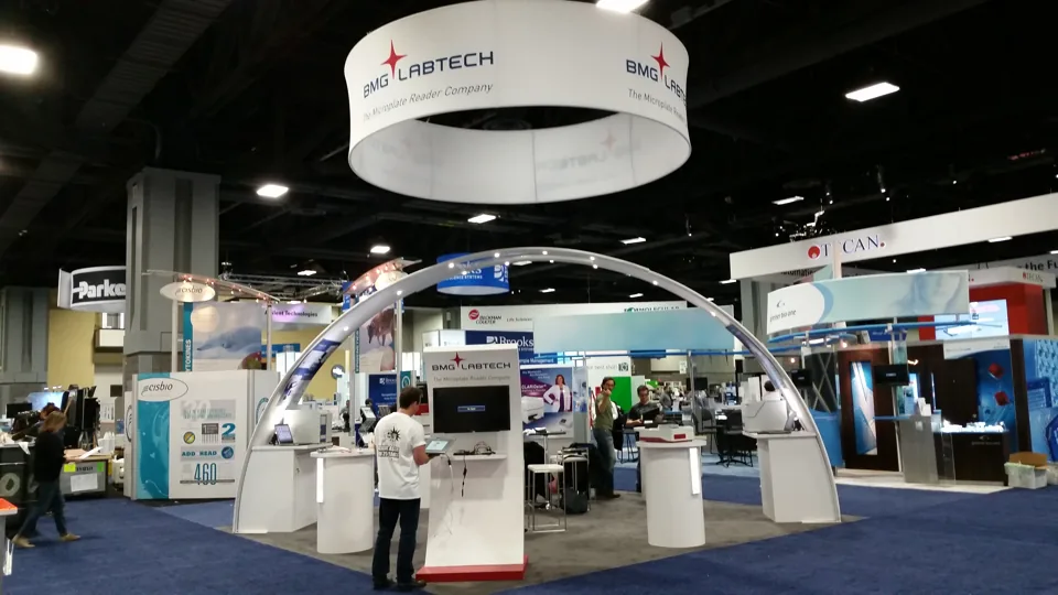 BMG Labtech exhibit with a large white hanging ring and arch