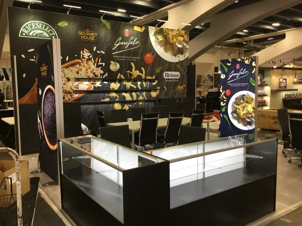 Riviana exhibit with dark graphic walls and glass display counter