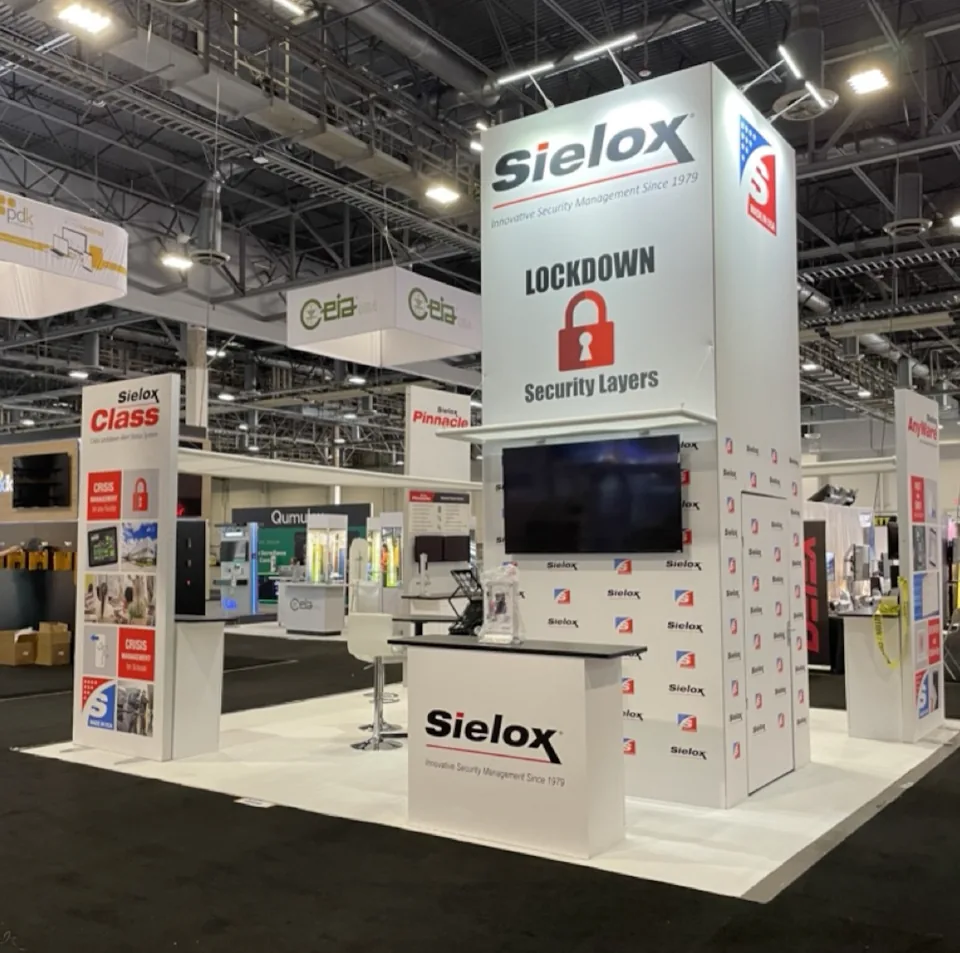Sielox exhibit with a tall white tower and product wall