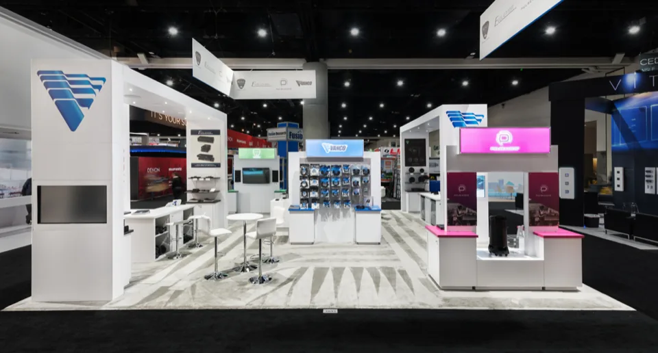 Vanco exhibit with white counters, product wall and a magenta accent bay